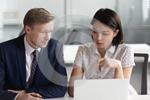 Asian businesswoman and Caucasian businessman working discussing project