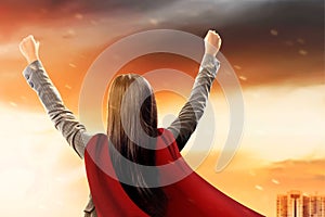 Asian businesswoman with a cloak flying like a superhero