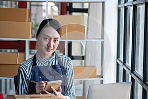 An Asian businesswoman enjoys his online SME business selling products, profiting from opening an online store, and taking orders