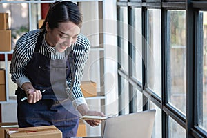 An Asian businesswoman enjoys his online SME business selling products, profiting from opening an online store, and taking orders