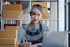 An Asian businesswoman enjoys his online SME business selling products, profiting from opening an online store, and taking orders