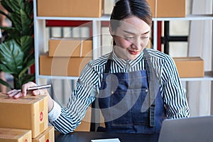 An Asian businesswoman enjoys his online SME business selling products, profiting from opening an online store, and taking orders