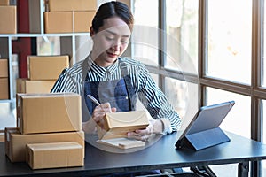 An Asian businesswoman enjoys his online SME business selling products, profiting from opening an online store, and taking orders