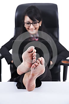 Asian businesswoman with Feet Up on a desk