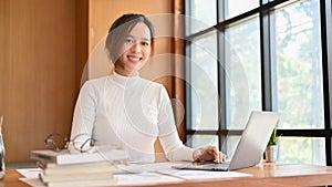 Asian businesswoman or female financial analysts working at her office desk