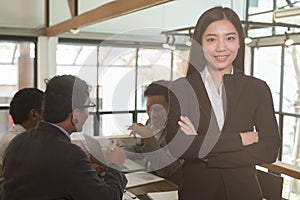 Asian businesswoman with folded hands smiling at camera. confide