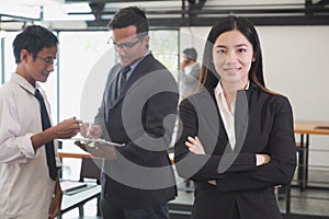 Asian businesswoman with folded hands smiling at camera. confide
