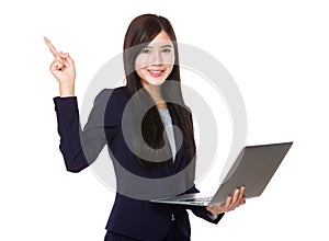 Asian businesswoman hold with notebook computer and finger point