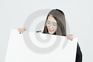 Asian businesswoman holding blank white card board sign.