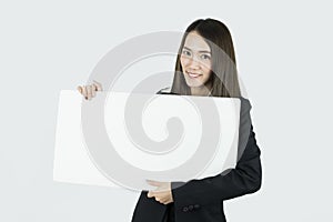 Asian businesswoman holding blank white card board sign.