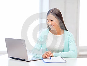 Asian businesswoman with laptop and documents