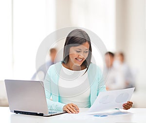 Asian businesswoman with laptop and documents