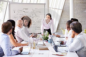 Asian Businesswoman Leading Meeting At Boardroom Table