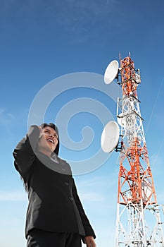 Asian businesswoman on phone and antenna