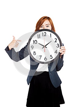 Asian businesswoman point to a clock over her face
