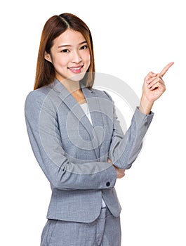 Asian businesswoman pointing to empty space