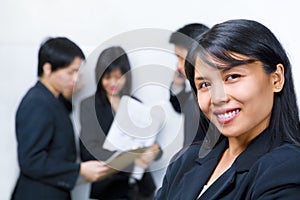 Asian businesswoman posing in front of the other