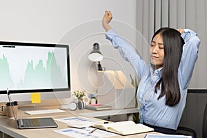 Asian businesswoman is relaxing after overtime working in a office