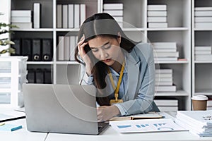 Asian businesswoman are stressed and tired from work sitting at desk in the office, feeling sick at work, stress from