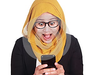 Asian businesswoman surprised, amazed expression looking at her phone
