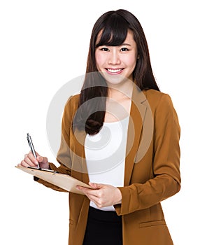 Asian Businesswoman take note on clipboard