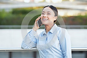 Asian Businesswoman Talking on the Phone On the Street