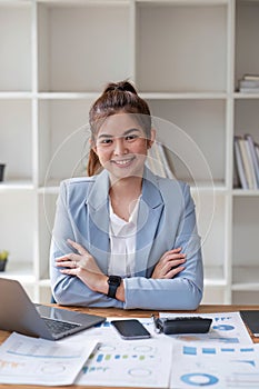 Asian businesswoman use laptop computer in office The Internal Revenue Service audit document balance calculation report