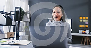Asian businesswoman using laptop computer, online video call meeting at home office. Woman working from home