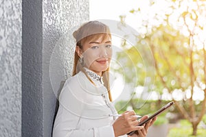 Asian businesswoman using tablet in office