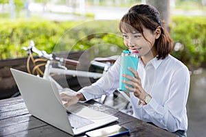 Asian businesswoman work in park