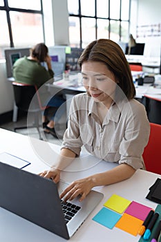 Asian businesswoman working in creative office