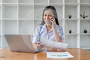 Asian businesswoman working for financial graphs showing results about their investments, planning successful business