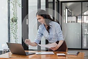 Asian businesswoman working for financial graphs showing results about their investments, planning successful business