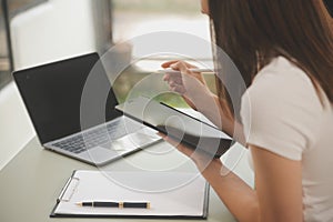 Asian businesswoman working on laptop computer Look for job online, freelance looking and typing on notebook on table, lifestyle