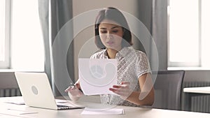 Asian businesswoman working with laptop documents write notes in office