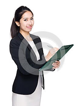 Asian businesswoman write on clipboard