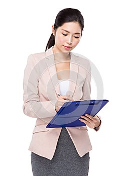 Asian businesswoman write on clipboard