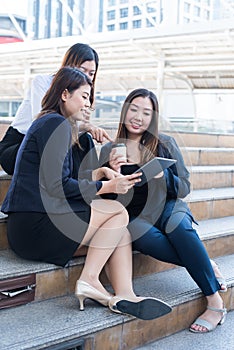 Asian businesswomen is working on laptop with colleague and teamwork.