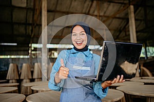 asian businness woman working using laptop with shows thumbs up