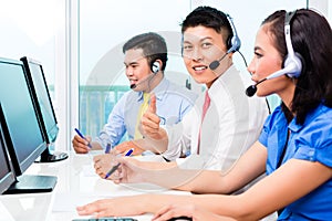 Asian call center agent team on phone