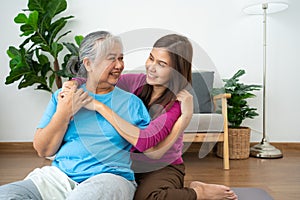 Asian careful caregiver or nurse taking care of the patient in a home.  Concept of happy retirement with care from a caregiver and