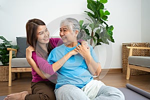 Asian careful caregiver or nurse taking care of the patient in a home.  Concept of happy retirement with care from a caregiver and