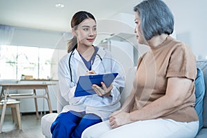 Asian caregiver psychology doctor examine and listen to woman patient. Young beautiful Woman nurse give advise and consult to help