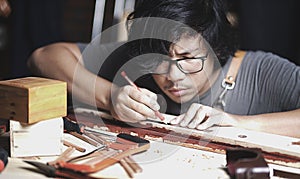 Asian Carpenter Working in Woodworking Workshop. Making Line wit