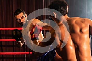 Asian and Caucasian Muay Thai boxer unleash kick attack. Impetus