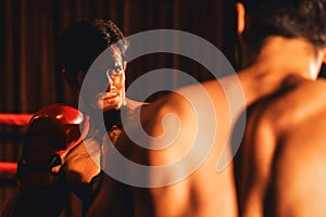 Asian and Caucasian Muay Thai boxers exchanging punch. Impetus