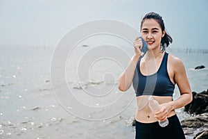 Asian caucasian woman practicing yoga at seashore