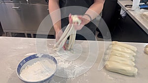 Asian chef preparing handmade pulled noodles