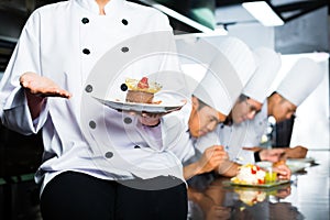 Asian Chef in restaurant kitchen cooking