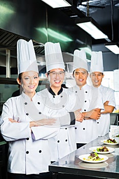 Asian Chef in restaurant kitchen cooking